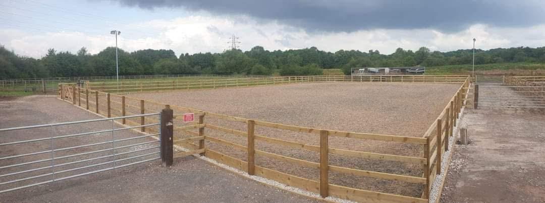 Fenced all-weather outdoor arena at Middleton Livery Yard