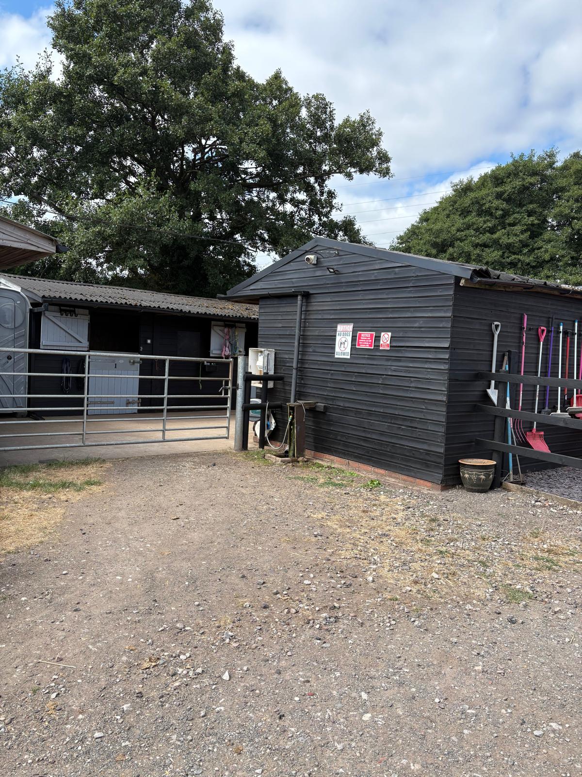 Entrance to Middleton Livery Yard stable block with gate and security camera
